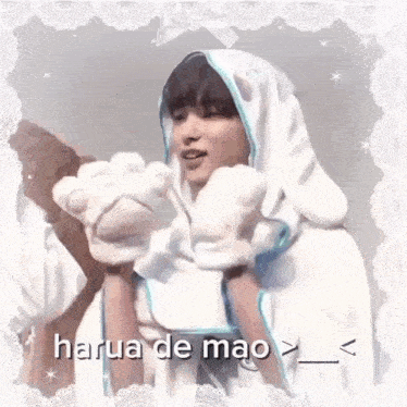 a person wearing a white hoodie with bunny ears and paws .