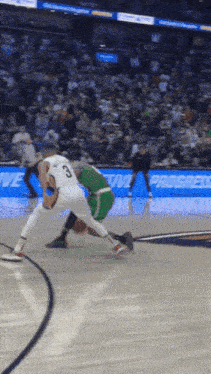 a basketball player with the number 8 on his jersey is playing against another player