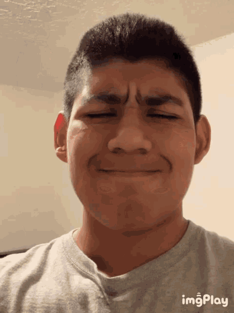 a young man making a funny face with imgplay displayed on the bottom right