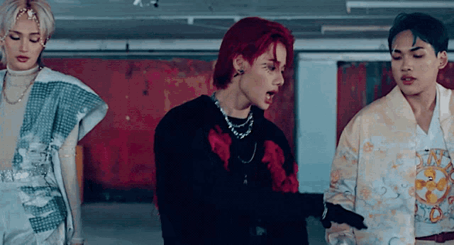 a man with red hair is standing next to another man