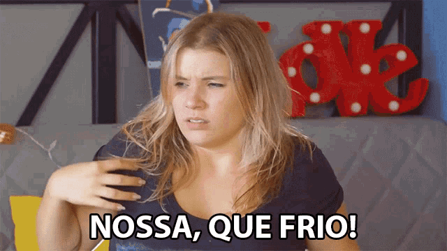 a woman says " nossa que frio " in front of a red sign that says ok
