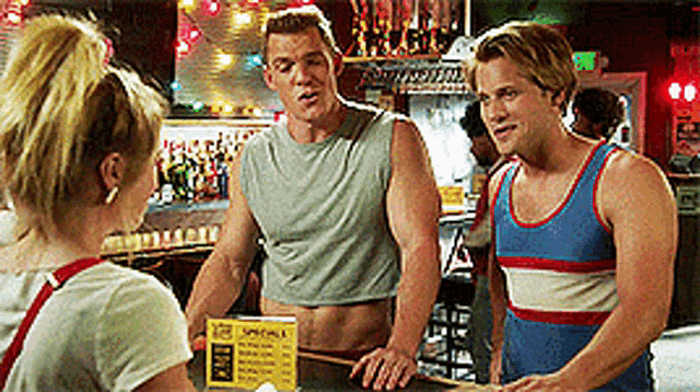 a man in a crop top is talking to a woman