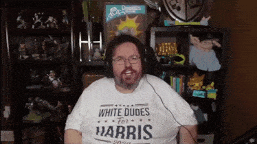 a man wearing a white t-shirt that says white dudes for harris