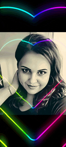 a black and white photo of a woman with a neon heart around her