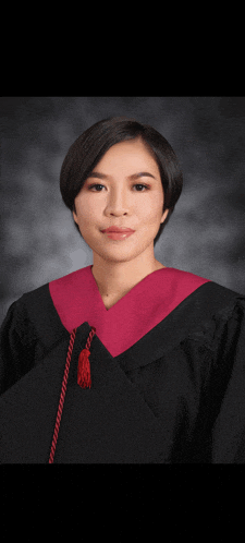 a woman in a graduation cap and gown poses for a photo