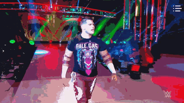 a man wearing a shirt that says dale gas walks on a stage