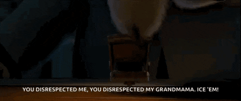 a cat in a suit is sitting in a chair and saying you disrespected me you disrespected my grandmama .