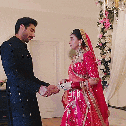 a man and a woman are standing next to each other in a room