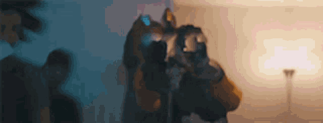 a group of people in gas masks are standing in a room .