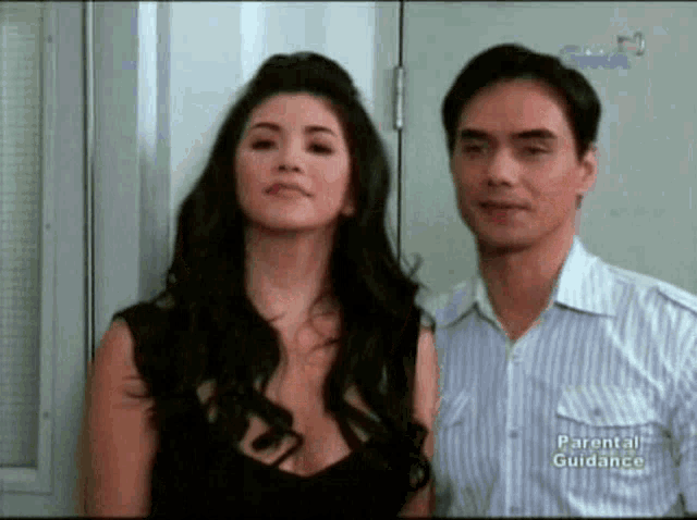 a man and a woman are standing next to each other with parental guidance written on the back of their shirt
