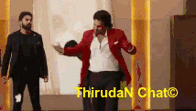a man in a red jacket is dancing in front of a sign that says thiruda chat on it