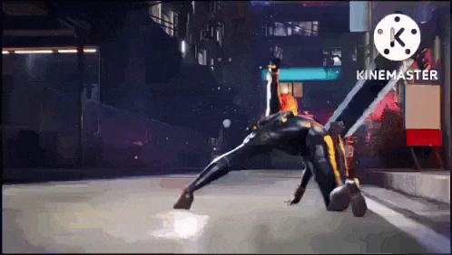 a person in a black and yellow suit is doing a trick on the ground .