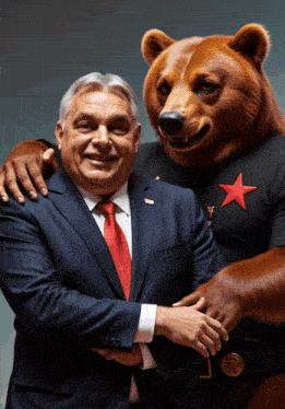 a man in a suit and tie is standing next to a bear wearing a red star shirt