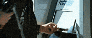 a person is using an atm machine that says redteller