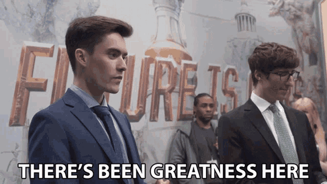 two men shaking hands in front of a sign that says failure is