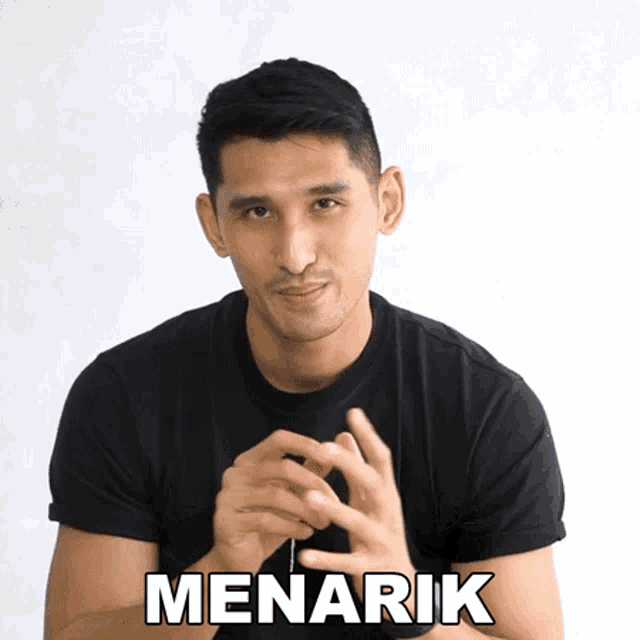 a man in a black shirt is making a gesture with his hands and the word menarik is below him