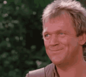 a close up of a man 's face with a smile on it