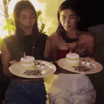 two women are holding plates with cakes on them that say happy birthday