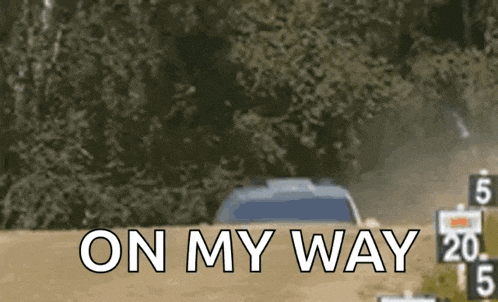 a car is driving down a dirt road and the words on my way are on the screen