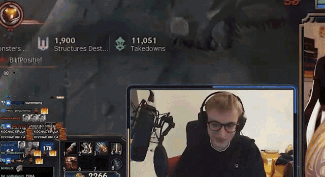 a man wearing headphones and glasses is playing a video game on a screen that says ' takedowns ' on it