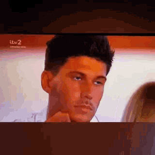 a close up of a man 's face on a television .