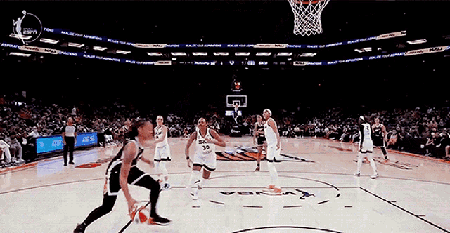 a basketball game is being played in a stadium with ads for at & t in the background