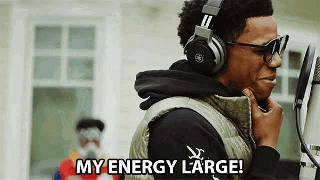 a man wearing headphones and glasses says " my energy large "