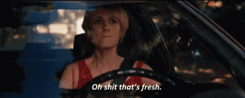 a woman is driving a car and says oh shit that 's fresh .