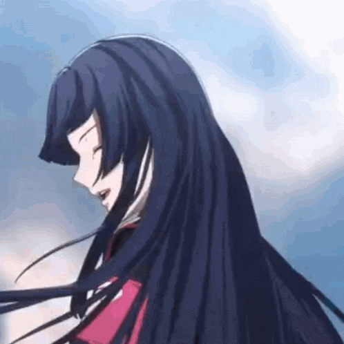 a girl with long black hair is standing in front of a blue sky with her hair blowing in the wind .