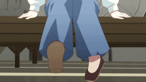 a person sitting on a bench with their hands on the edge