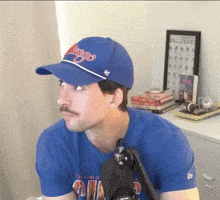 a man wearing a chicago hat and a blue t-shirt