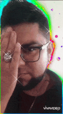 a man with glasses and a ring on his finger has a rainbow background