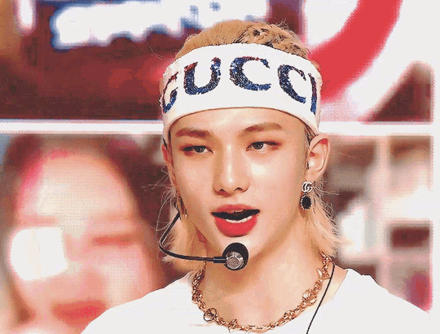 a young man wearing a headband that says gucci on it