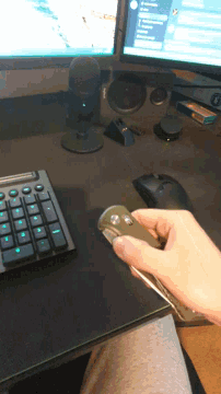 a person holding a knife in front of a logitech speaker
