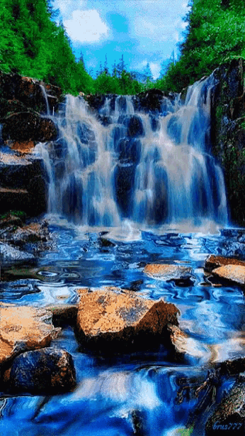 a painting of a waterfall with a blue sky and trees in the background has a watermark on the bottom right