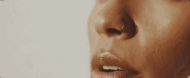 a close up of a woman 's face with her eyes closed