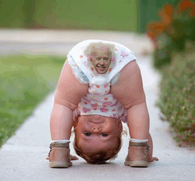 a baby wearing a diaper with a picture of biden on it is doing a handstand