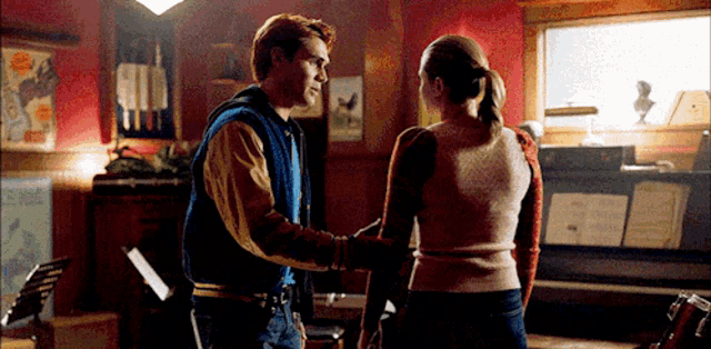 a man and a woman are dancing in a room .