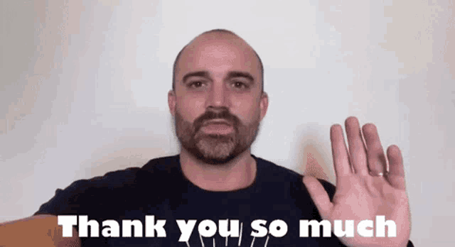 a man with a beard is giving a thank you gesture with his hand