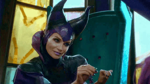 a woman in a purple and black costume with horns