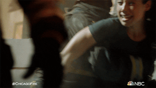 a woman in a black shirt is smiling in a chicago fire advertisement