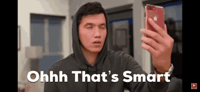 a man in a hoodie is taking a selfie with his phone and the caption says ohh that 's smart
