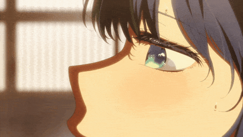 a close up of a girl 's face with blue hair and green eyes