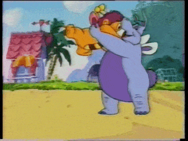 a cartoon elephant is holding a stuffed animal in his arms