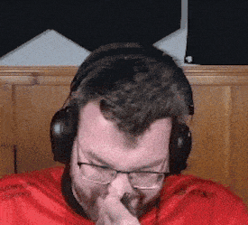a man wearing headphones and a red shirt with at & t written on it