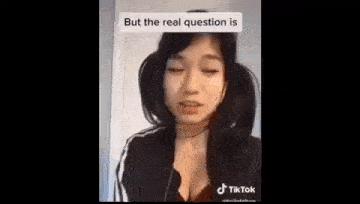 a woman is making a funny face while talking on a cell phone .