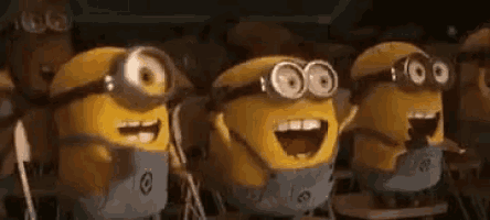 a group of minions are standing next to each other with their mouths open and smiling .