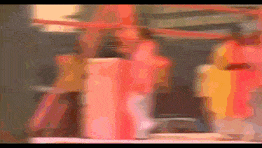a blurred image of a carousel with a red and yellow background