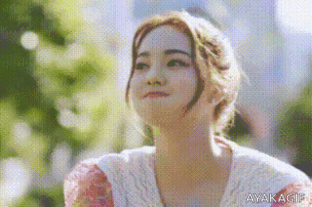 a close up of a woman 's face with a blurred background .