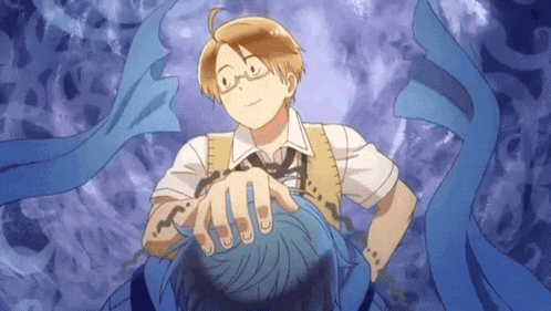 a man with glasses is holding a blue object in his hand
